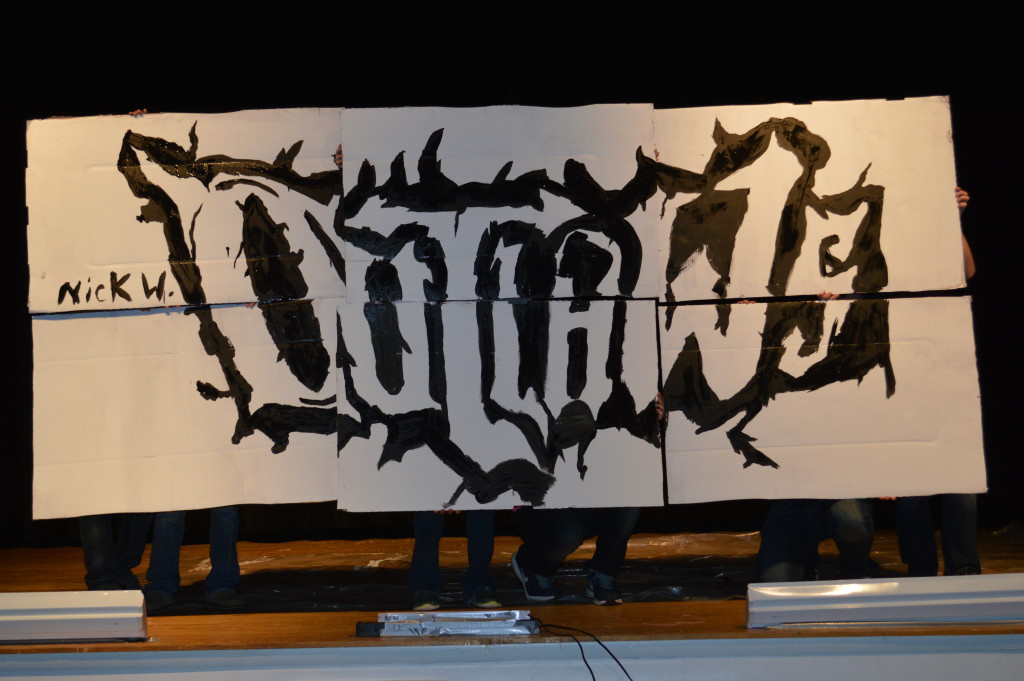 Art I students collaborated to form the word 'Outlaws' with their individual paintings.